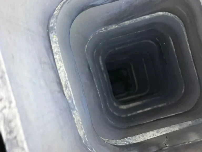 View straight down a clean square chimney flue liner after sweeping