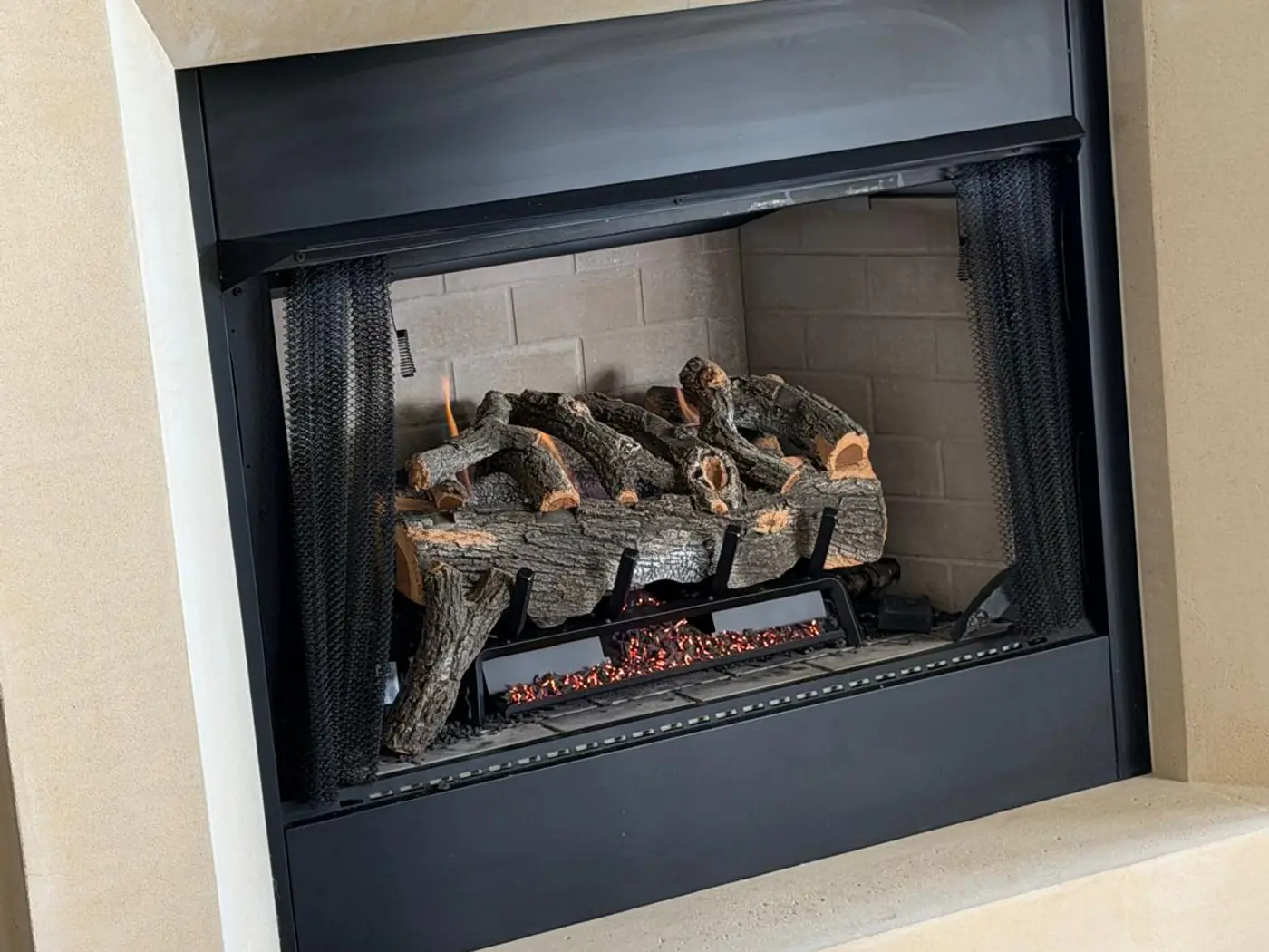 Clean fireplace insert with a gas log set fitted after service