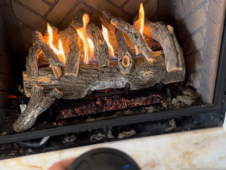 Gas log set burning in a herringbone brick firebox after service